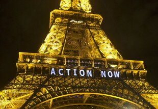 In this Sunday, Dec. 6, 2015, photo, the Eiffel Tower lights up with the slogan"Action Now"referring to the COP21, United Nations Climate Change Conference in Paris. The carbon footprint for the COP21 conference runs to thousands of tons, for the some 40,000 people, including heads of state, negotiators, activists and journalists, in Paris to hash out a ground-breaking international agreement to put a brake on global warming. (AP Photo/Michel Euler)